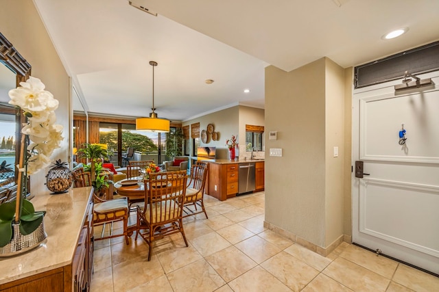 dining space with ornamental molding and light tile patterned floors