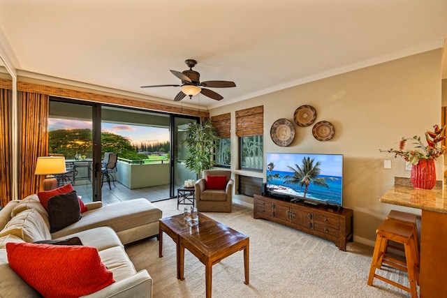 carpeted living room featuring crown molding and ceiling fan