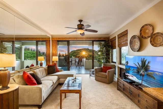 carpeted living room featuring ceiling fan and a wealth of natural light