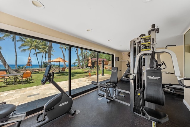 exercise room with a water view