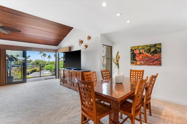 carpeted dining area with lofted ceiling and ceiling fan