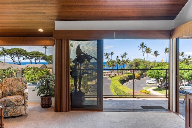 entryway with wood ceiling and carpet flooring