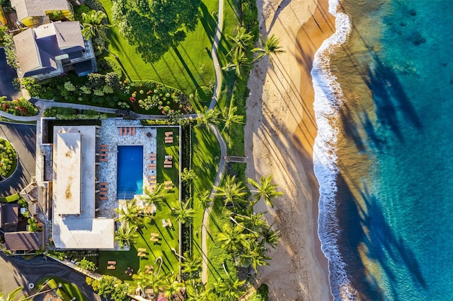 birds eye view of property with a water view and a beach view