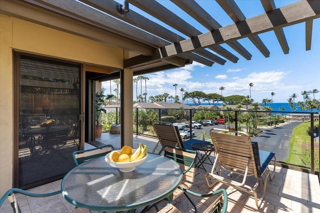 view of patio featuring a pergola and a water view