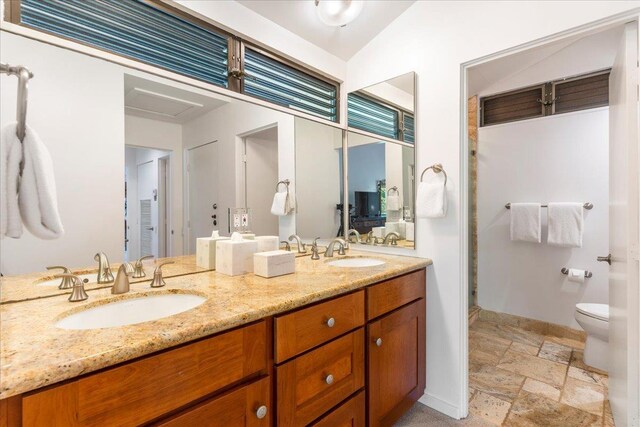 3600 Wailea Alanui Dr Unit 708, Kihei, HI 96753 - full bath with stone tile flooring, toilet, double vanity, baseboards, and a shower