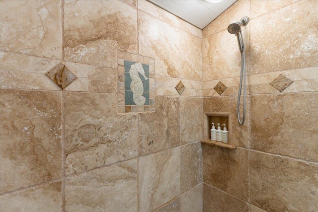 interior details featuring a tile shower