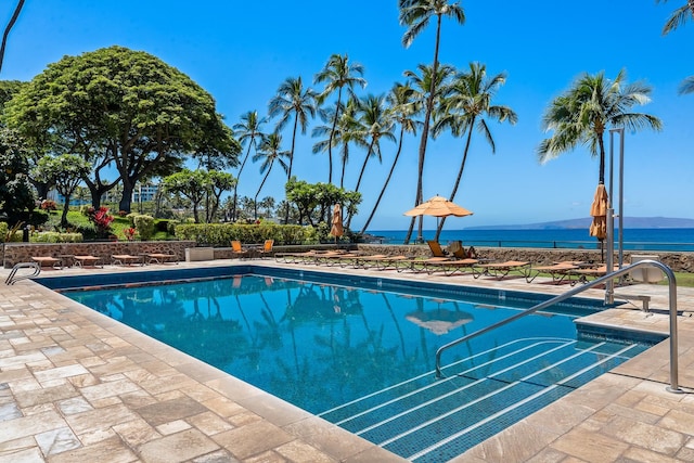 view of swimming pool with a water view