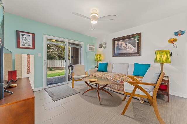 living room featuring an AC wall unit and ceiling fan