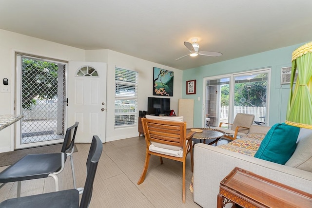 living room with ceiling fan, a wall unit AC, and plenty of natural light