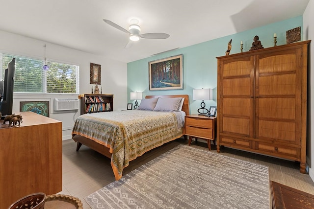 bedroom featuring ceiling fan and a wall unit AC