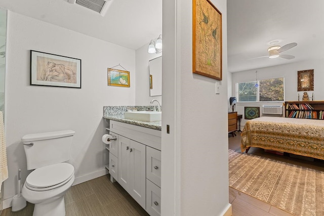 bathroom with ceiling fan, vanity, and toilet