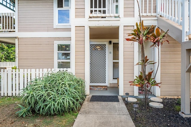 view of exterior entry featuring a balcony