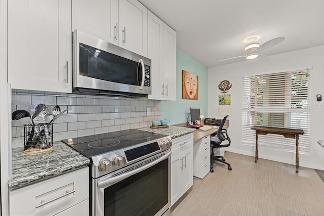 kitchen with appliances with stainless steel finishes, tasteful backsplash, white cabinets, stone countertops, and ceiling fan