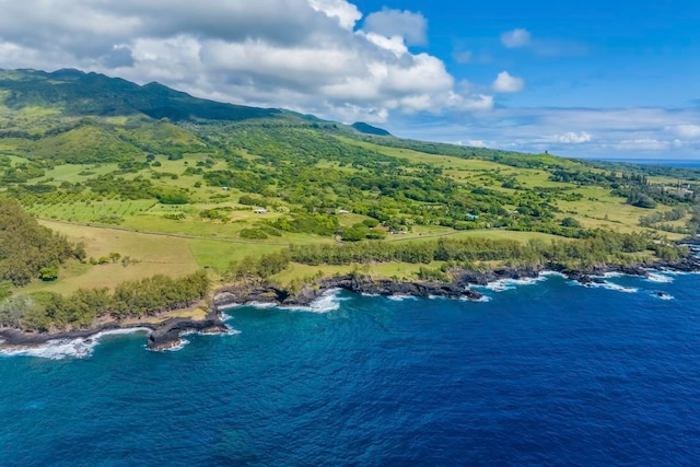 aerial view featuring a water and mountain view