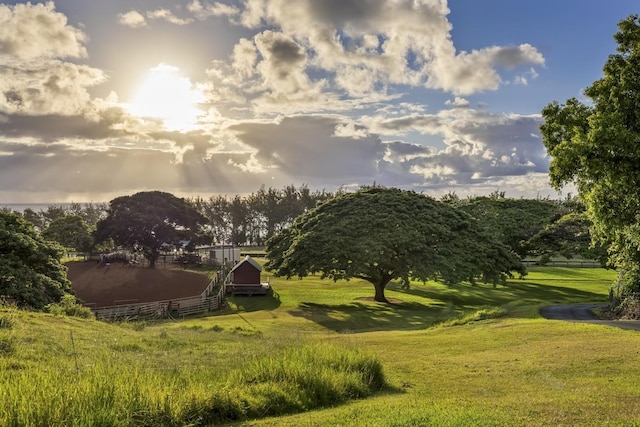 view of property's community with a rural view and a lawn