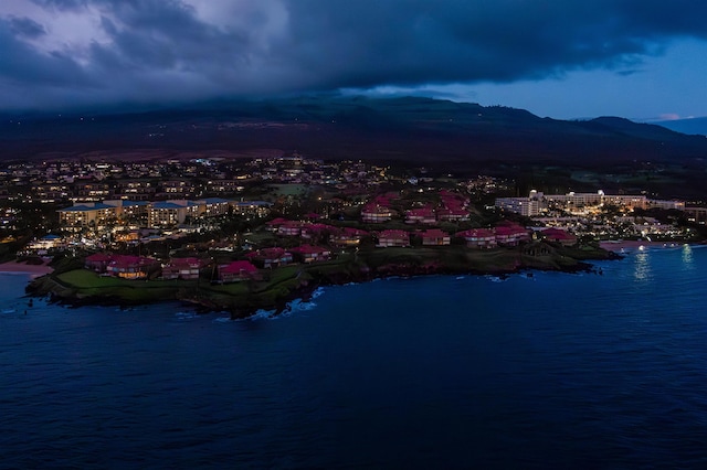 drone / aerial view with a water and mountain view