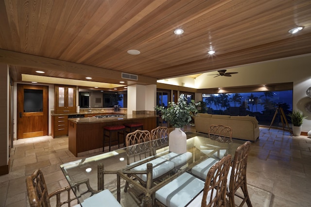 dining space featuring ceiling fan and wooden ceiling