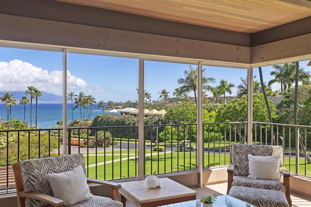 sunroom / solarium with a water view and wood ceiling