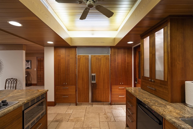 kitchen featuring built in appliances, ceiling fan, wooden ceiling, and dark stone countertops