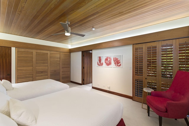 carpeted bedroom featuring access to outside, ceiling fan, and wooden ceiling