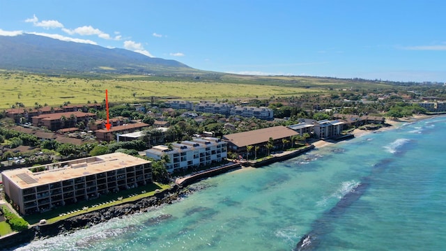 birds eye view of property with a water and mountain view