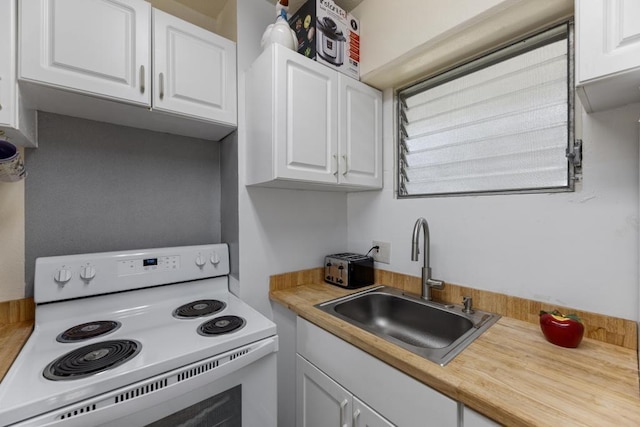 kitchen featuring white electric range oven, sink, and white cabinetry