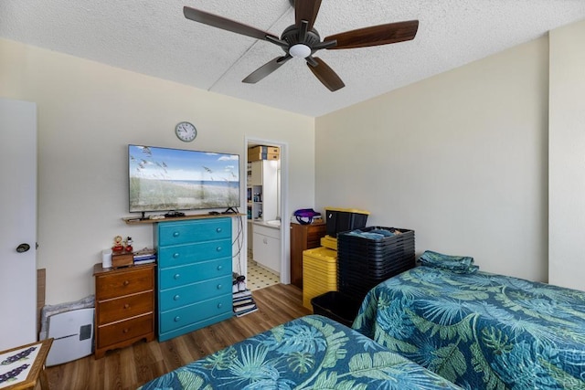 bedroom with ceiling fan, connected bathroom, wood-type flooring, and a textured ceiling