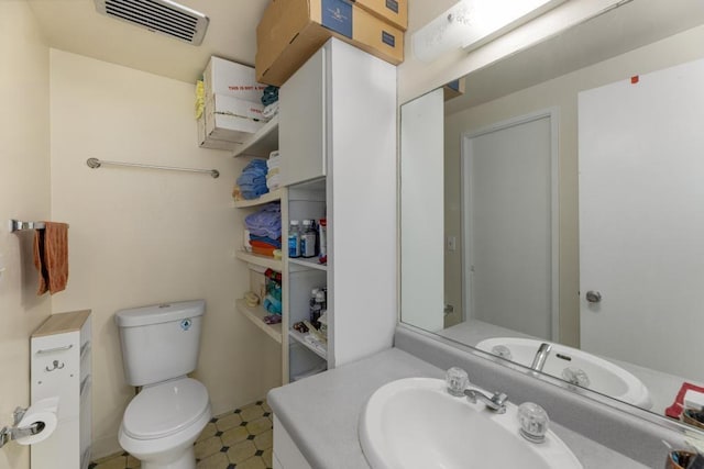 bathroom with toilet and vanity