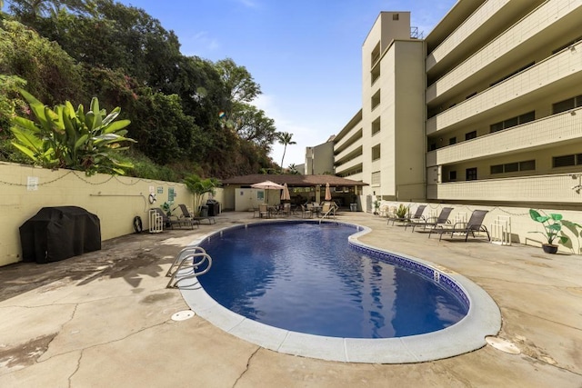 view of swimming pool featuring a patio area, a gazebo, and a grill