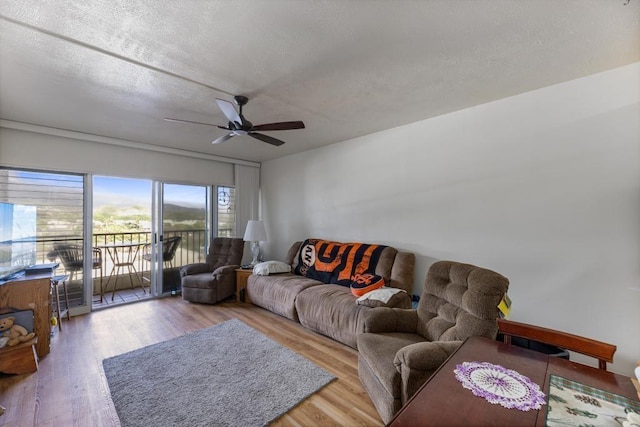 living room featuring hardwood / wood-style flooring and ceiling fan