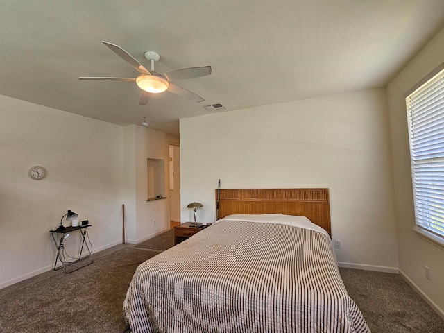 bedroom with dark colored carpet and ceiling fan