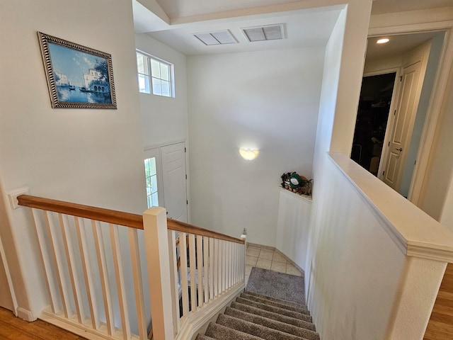 stairs featuring hardwood / wood-style flooring