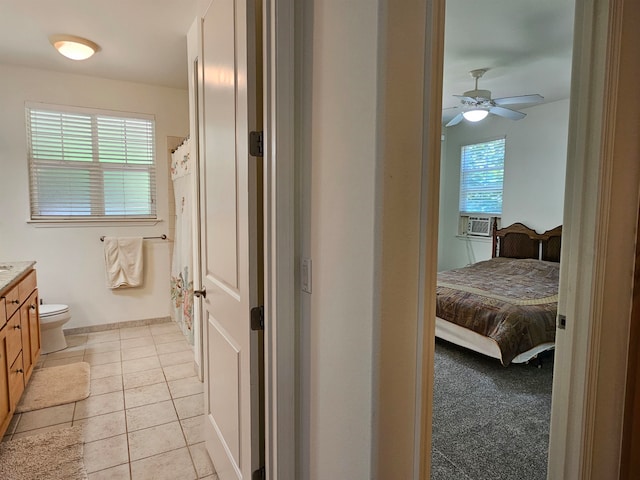 carpeted bedroom with cooling unit and ceiling fan