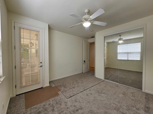 interior space featuring carpet, ceiling fan, and a closet