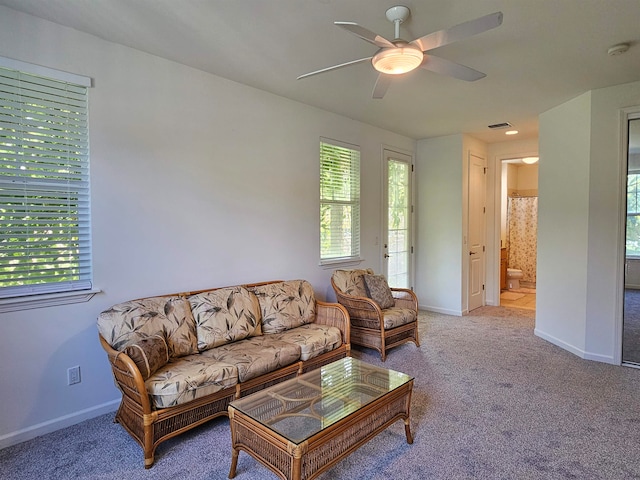 living room with ceiling fan and carpet floors