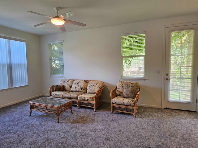 living room with ceiling fan and carpet