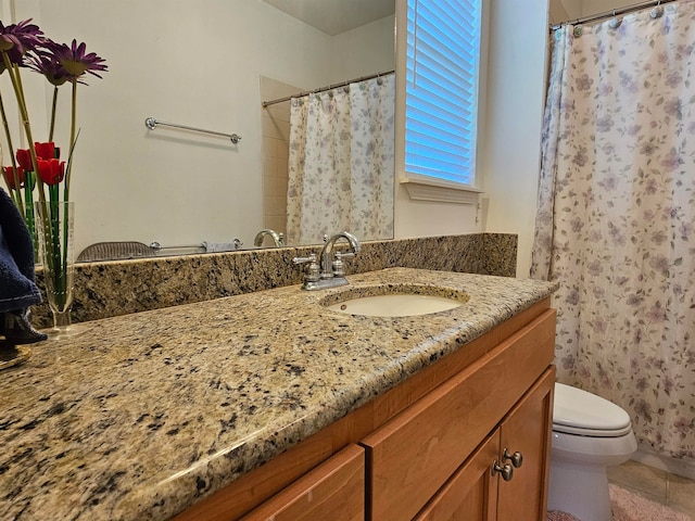 bathroom featuring vanity, toilet, a shower with curtain, and tile patterned floors