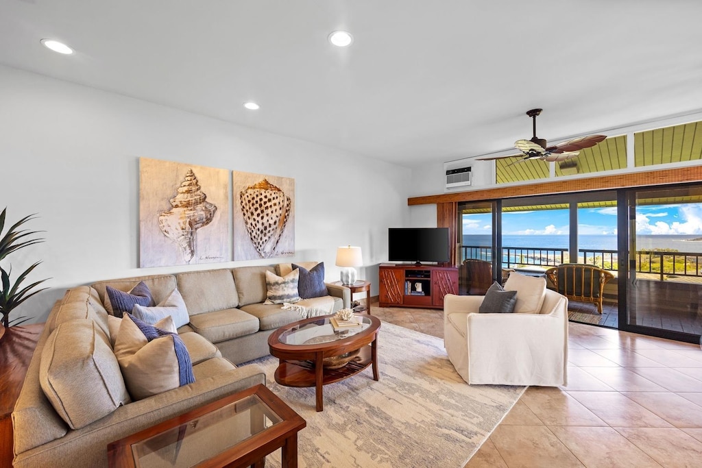 living room with ceiling fan and light tile patterned floors