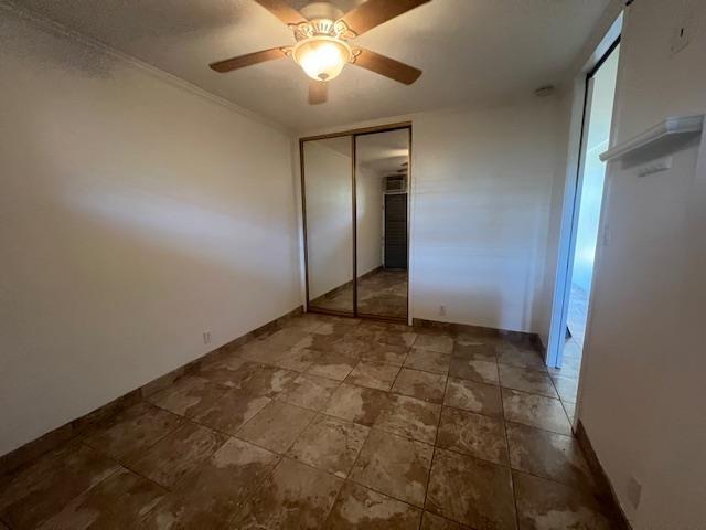 3959 Lower Honoapiilani Rd Unit 304, Lahaina, HI 96761 - unfurnished bedroom with ceiling fan, baseboards, and a closet