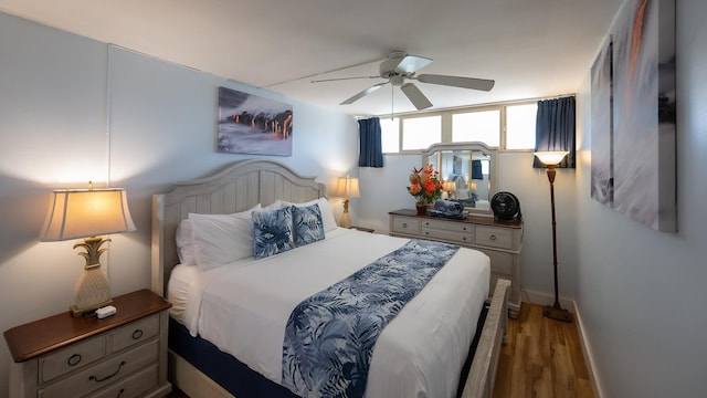 bedroom with ceiling fan and dark hardwood / wood-style floors