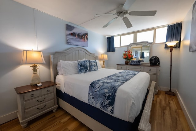 bedroom with ceiling fan and dark wood-type flooring