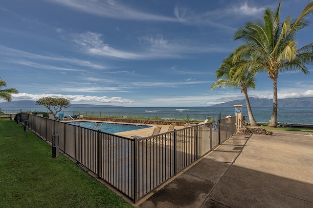 view of swimming pool featuring a patio area and a water and mountain view