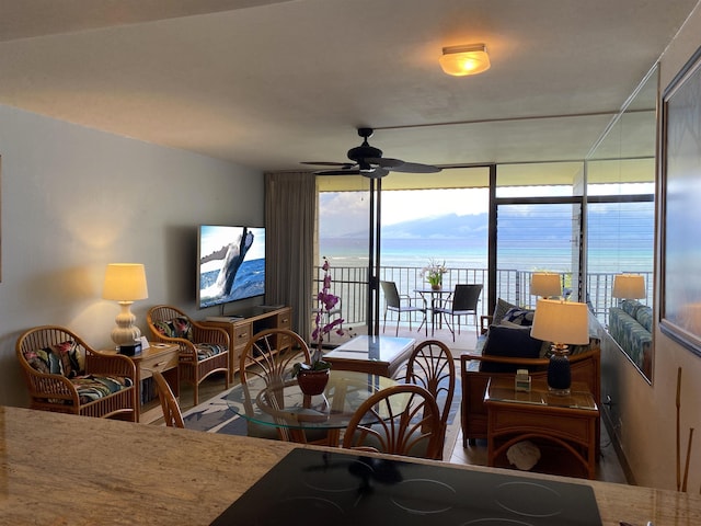 dining space featuring ceiling fan and floor to ceiling windows