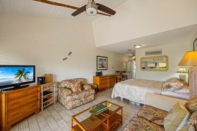 bedroom featuring light hardwood / wood-style floors, ceiling fan, and high vaulted ceiling