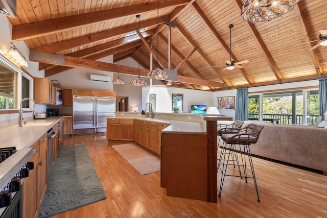 kitchen with open floor plan, stainless steel built in refrigerator, wooden ceiling, ceiling fan, and an AC wall unit