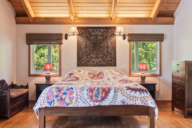 bedroom featuring wooden ceiling, multiple windows, and light wood-type flooring