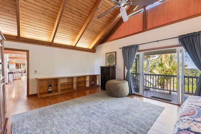 living area with beamed ceiling, wooden ceiling, wood finished floors, ceiling fan, and high vaulted ceiling