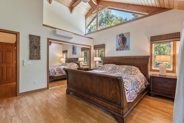 bedroom featuring wooden ceiling, an AC wall unit, wood finished floors, multiple windows, and high vaulted ceiling
