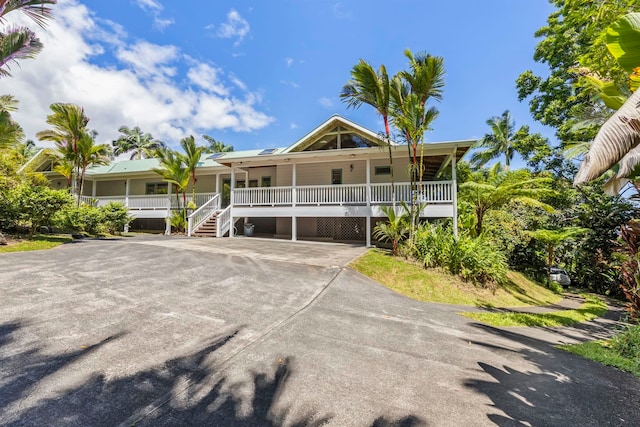 view of front of property with a porch and asphalt driveway