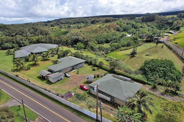 drone / aerial view featuring a wooded view